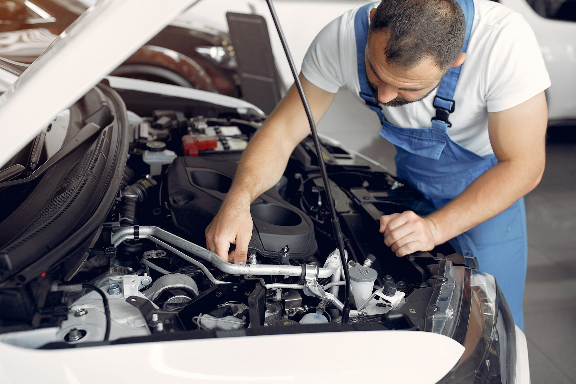 Mechanic performing vehicle maintenance